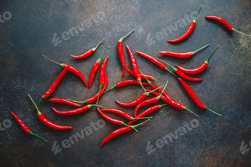 Preview: A lot of chili peppers on a kitchen table. Top view.