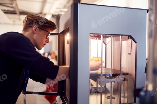 Preview: Male College Student Studying Engineering Using 3D Printing Machine