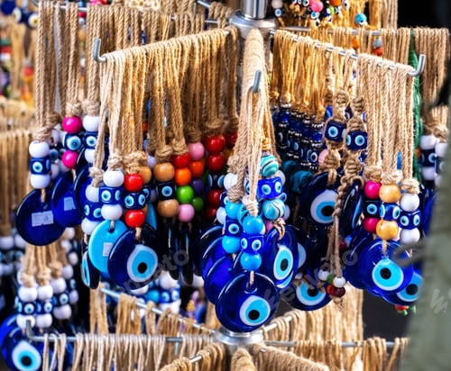 Preview: Key chains with Turkish traditional amulets with blue eyes hang on the window of a souvenir shop
