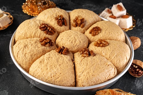Preview: Turkish dessert baklava with nuts on black background