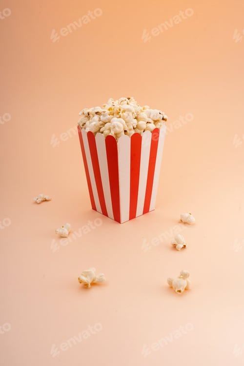 Preview: Striped popcorn bucket on a tan background.