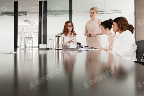 Preview: Four businesswomen meeting in conference room