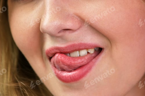 Preview: Young woman showing tongue and flirting.