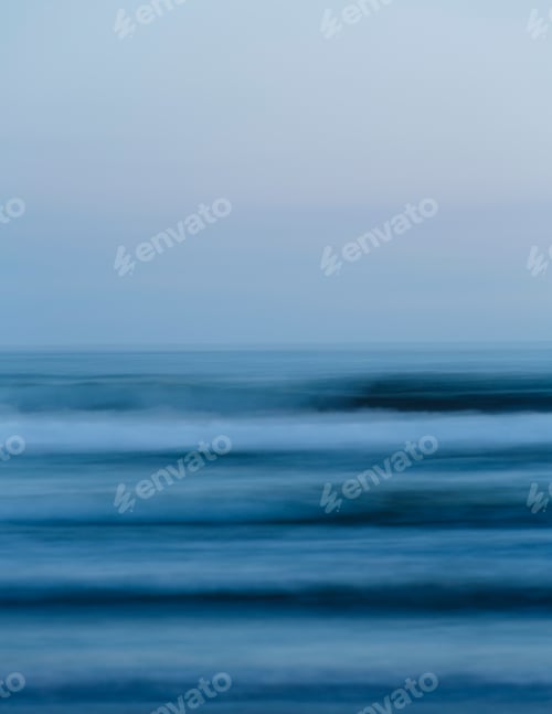 Preview: Ocean waves and the view to the horizon over the sea at dusk from the beach.