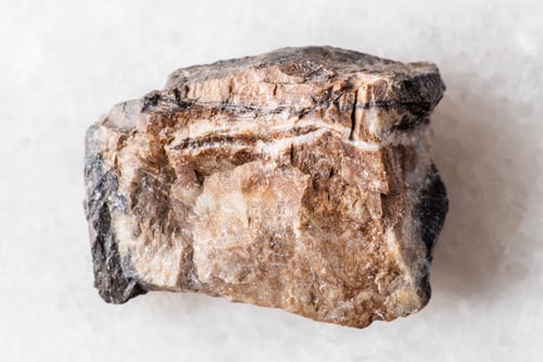Preview: sample of raw rhodonite rock on white marble