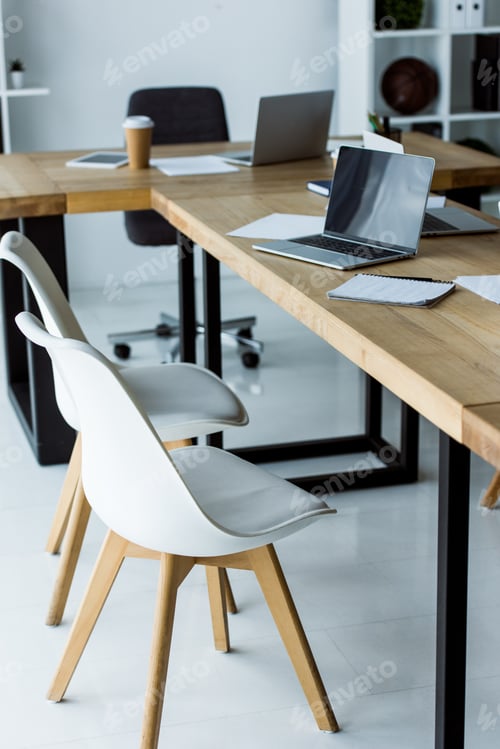 Preview: interior of start up office with laptops and coffee in paper cups on tables