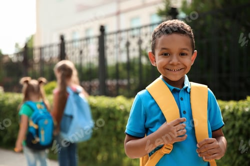 Preview: Cute little child with backpack outdoors. Elementary school