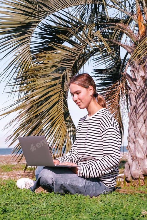 Preview: Remote work.Girl freelancer works remotely sea shore. workation, remote work,leisure, work life bala