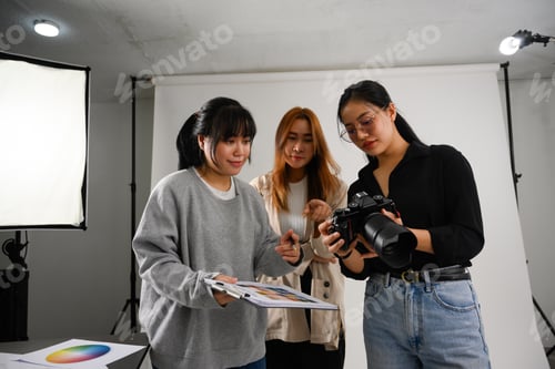 Preview: Beautiful creative female freelancer working at modern photography studio
