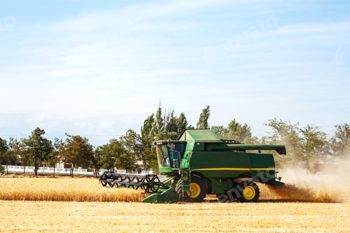 Preview: Time to harvest! Beautiful view of the work of the combine harvesting wheat. Harvester machine.