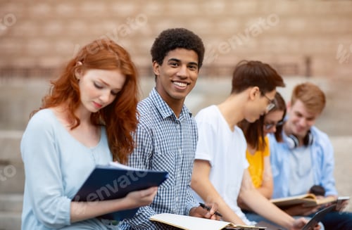 Preview: Multicultural Students Learning Preparing For Tests Sitting Outside University Building