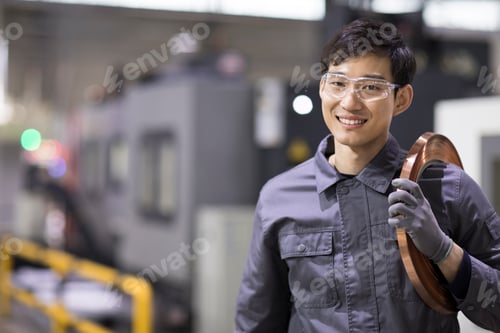 Preview: Confident Chinese engineer in the factory