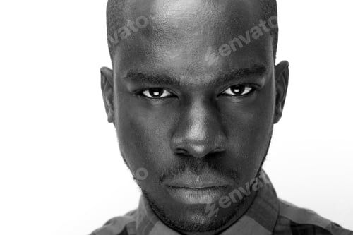Preview: Close up black and white of young black man staring