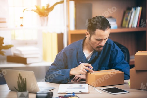 Preview: Small business owner packing in the box at workplace