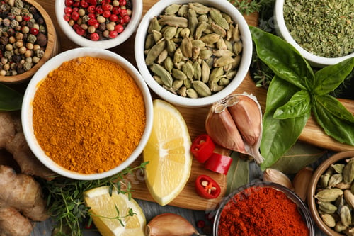 Preview: Different natural spices and herbs on table, flat lay