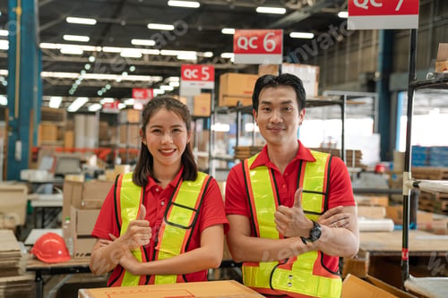 Preview: Portrait of staff worker standing in warehouse with his arm crossed looking at camera