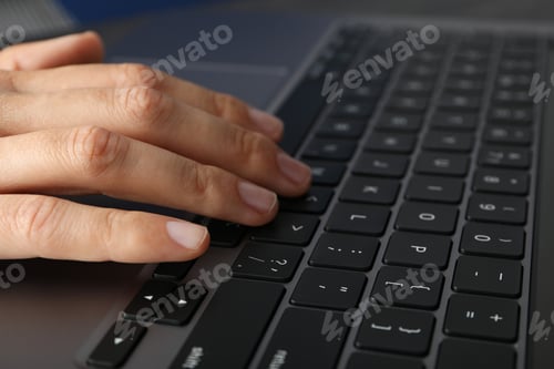 Preview: Hands on black laptop keyboard close up view