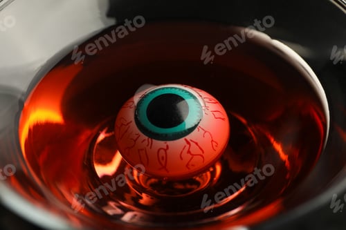 Preview: Decorated eye in glass with liquid, halloween concept