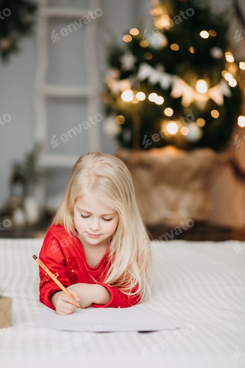 Preview: Young Girl Writing Christmas Letter at Home