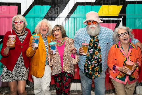 Preview: Group of happy senior friends with fancy clothing having party in the night