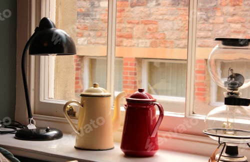 Preview: Retro lamps and metal teapots in windowsill