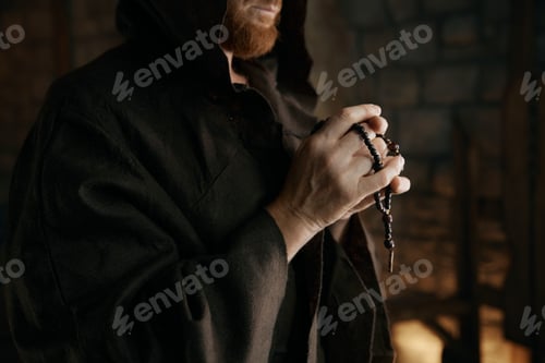 Preview: Cropped shot of monk praying or blessing with rosary beads in hands