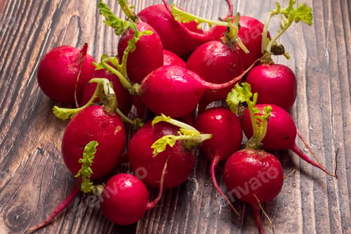 Preview: Close up of red ripe radishes on wooden background