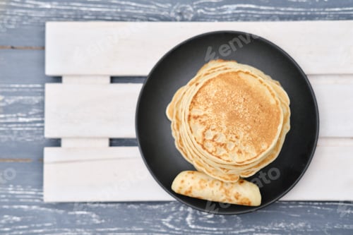 Preview: stack of classic american pancakes on a wooden rack.