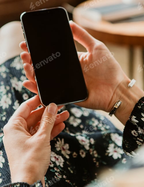 Preview: Woman using a mobile phone at home