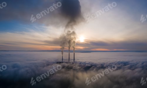Preview: Aerial view of coal power plant high pipes with black smoke moving up polluting atmosphere at sunset