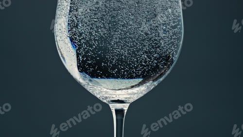 Preview: Air bubbles rising cup surface closeup. Pure refreshing water in transparent