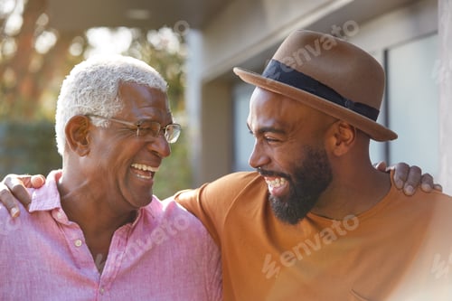 Preview: Senior Father Talking And Laughing With Adult Son In Garden At Home