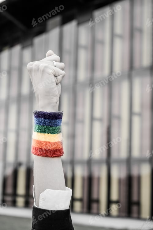 Preview: Close-up of closed fist with lgtbqi bracelet with selective saturation.