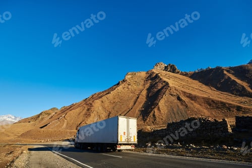 Preview: beautiful mountain landscape. ragged mountain peaks, sharp peaks brown mountains and a wagon rides
