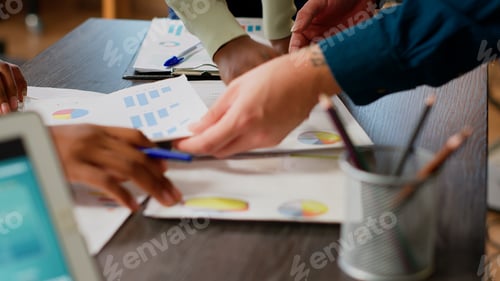 Preview: Business people looking at charts and diagrams on documents