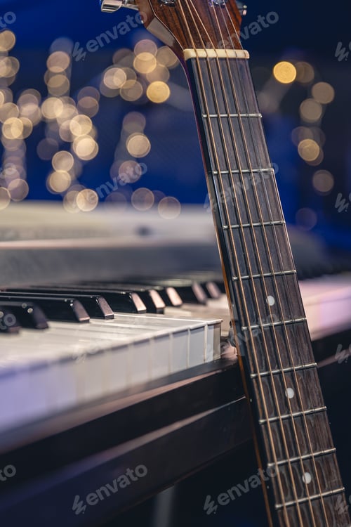 Preview: Guitar and piano keys close-up on a blurred background with bokeh.