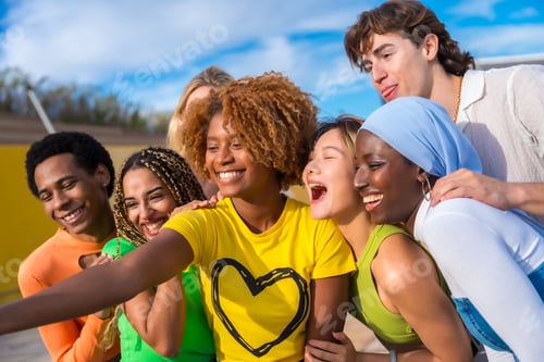 Preview: Multi-ethnic friends smiling and taking a selfie outdoors