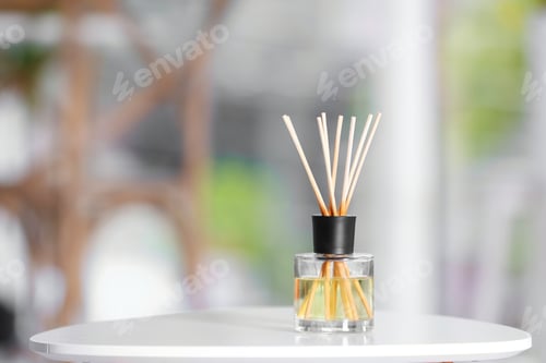 Preview: Aromatic reed air freshener on table against blurred background