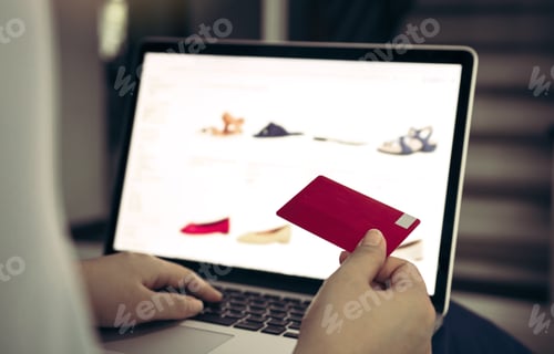 Preview: Close up woman hand holding credit card and typing laptop keyboard with shopping online concept.