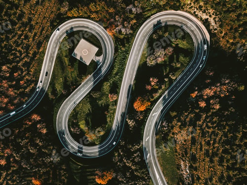 Preview: Aerial view of winding curved road with helipad and colourful autumn foliage in Italy
