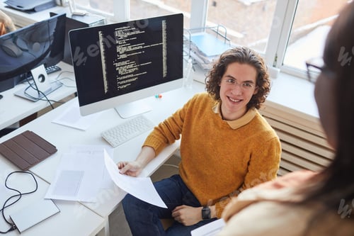 Preview: Smiling IT Programmer Working in Office