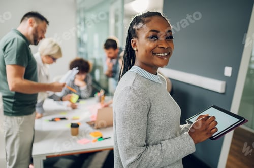 Preview: Businesswoman posing and smiling during a meeting in an office
