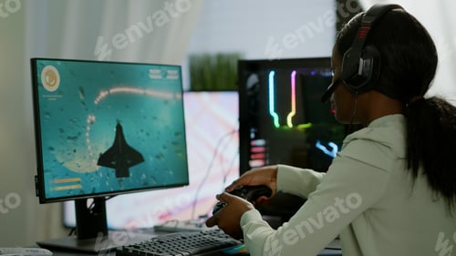 Preview: Pro african gamer playing online space shooter game on powerful computer