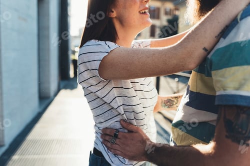 Preview: Cropped shot of romantic couple hugging on sidewalk