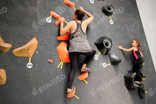 Preview: Mother and daughter climbing wall in gym