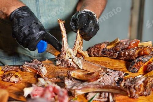 Preview: Chef Slicing Lamb Rack with Fresh Garnish