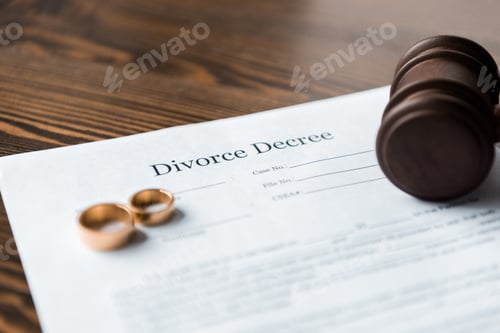 Preview: close-up view of divorce decree, wedding rings and wooden hammer