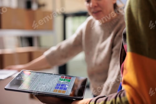 Preview: Stockroom team analyzing online orders on tablet computer