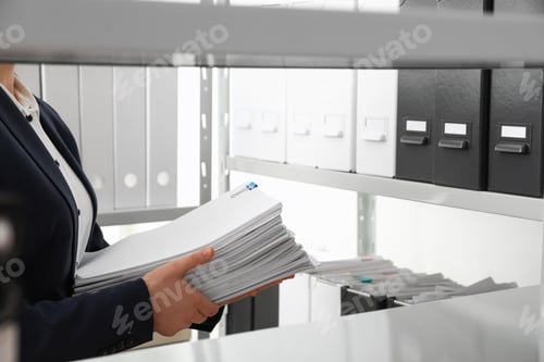 Preview: Female worker with documents in office, closeup. Space for text