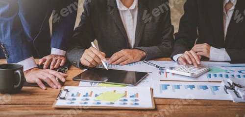 Preview: Close up business adviser partnership coworkers using a tablet to chart company financial statements
